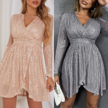 Glittrande festklänning med strass, långärmad, V-ringning, hög midja och asymmetrisk fåll