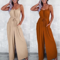 Sexig enfärgad fyrkantig hals ärmlös jumpsuit med patchfickor och korsad öppen rygg