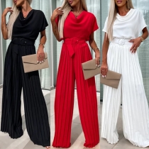 Elegant draperad halsringad kortärmad plisserad byxdress med vida ben och bälte
