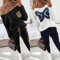 Avslappnat leopardmönstrat/fjärilsmönstrat set i två delar med rundhalsad t-shirt och byxor med dragsko