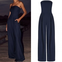 Elegant axelbandslös jumpsuit med vida ben och sidofickor