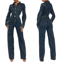Vintage jumpsuit i gammaltvättad denim med ståkrage och långärmad design samt främre knapprad