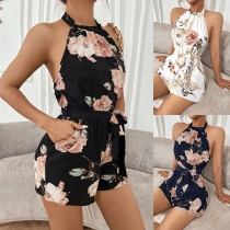 Trendig blommönstrad halterneck-jumpsuit med sidofickor och öppen rygg