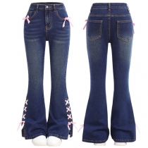 Gammaltvättade vida jeans med medelhög midja och rosettsnörningar i sidan