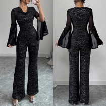 Skimrande paljettprydd jumpsuit i gasväv med draperad halsringning, långärmad rakskuren modell
