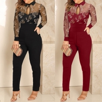 Sexig långärmad jumpsuit med ståkrage och blommigt broderi